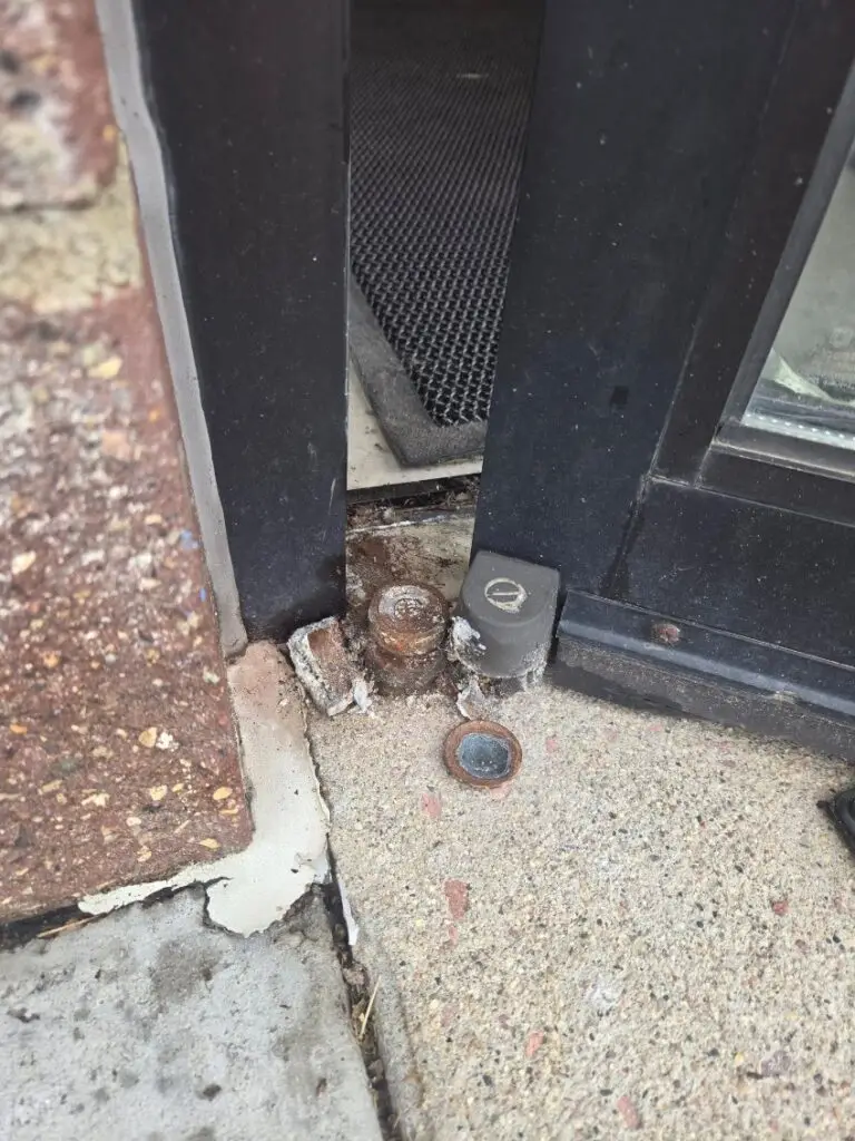 Storefront Door Hinge Repair in Sioux Falls — corroded hinge repair